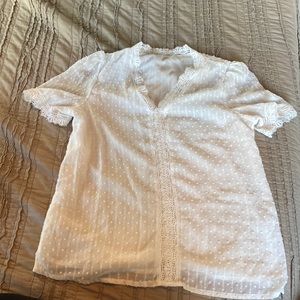 White blouse with lace like detail.